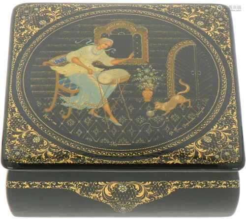 A Russian lacquer box with with depiction of a lady at a window with her needlework.