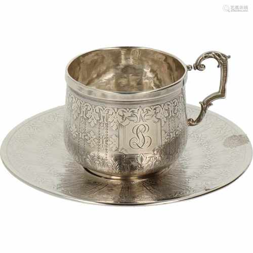 Silver cup and saucer.