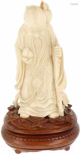 An ivory statuette of a scholar. China, late 19th century.