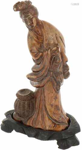 A stone statuette shaped as a fishing lady. China, 1st half 20th century.