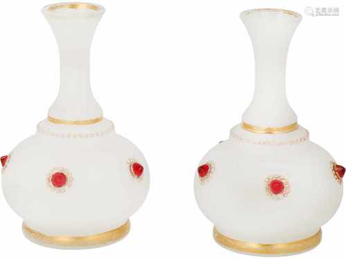 A set of wine glasses bejewelled with red stones.