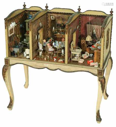 A softwooden dollhouse, consisting of three rooms amongst which a nursery, living room and