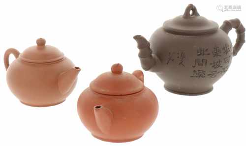 A lot of three terracotta miniature teapots, all marked underneath. China, 20th century.