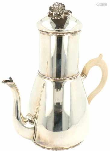 Silver coffee pot with filter.