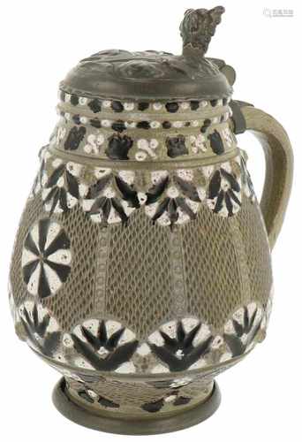 A 17th century Freiberg beer jug with pewter lid and resting on a base.