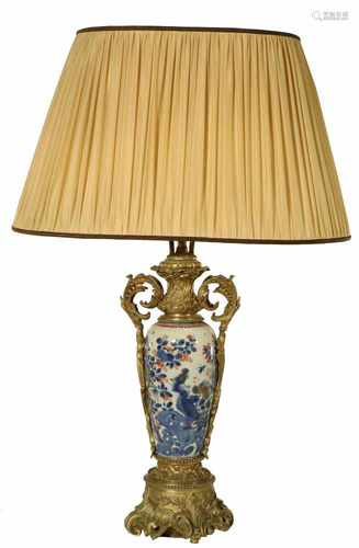 A porcelain vase with Imari décor, fitted as a lamp base with bronze mounts. 