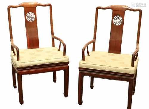 A pair of wooden chairs with silk cushions. China, 2nd half 20th century.