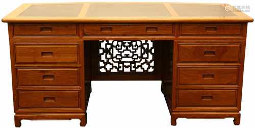 A mahogany desk with red leather inlay.