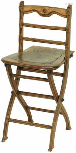 A wood folding chair with pierced seat. Ca. 1910 / 1920.