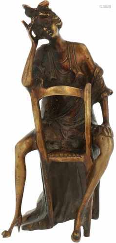 A bronze young woman seated on a chair. Second half 20th century.