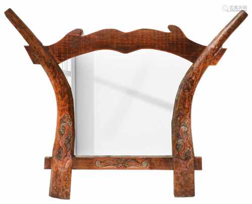 A wall mirror assembled from an Indonesian plough.