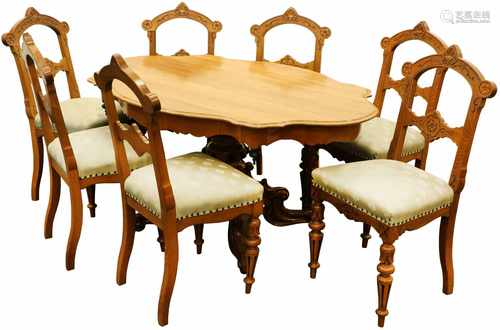 A fruitwood table on a single base, together with (7) matching oakwood chairs. Circa 1900.