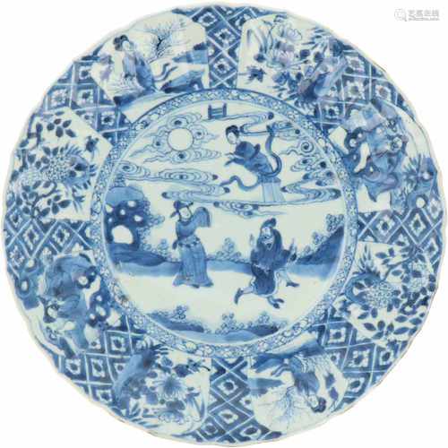 A lobed porcelain charger with sectioned décor of Chinese figures. China, Kangxi. 