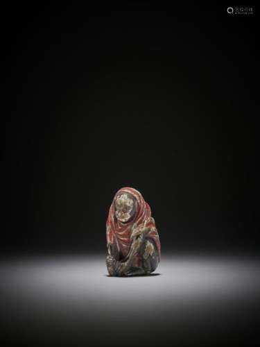 A RARE SAISHIKI NETSUKE OF A SEATED CLOTHED MONKEY…