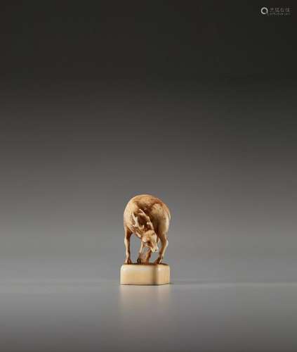 A VERY FINE AND RARE IVORY SEAL NETSUKE OF A DEER …