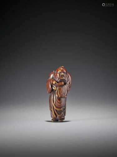 A LARGE STAINED IVORY NETSUKE OF A CHINESE IMMORTA…