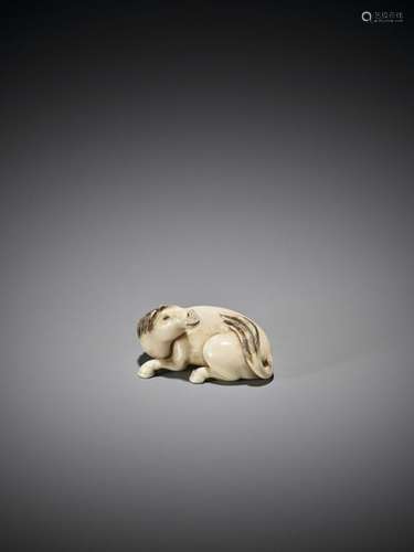 A FINE IVORY NETSUKE OF A RECUMBENT HORSE Unsigned…