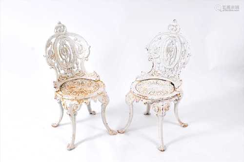 A pair of Victorian painted cast iron garden chairs