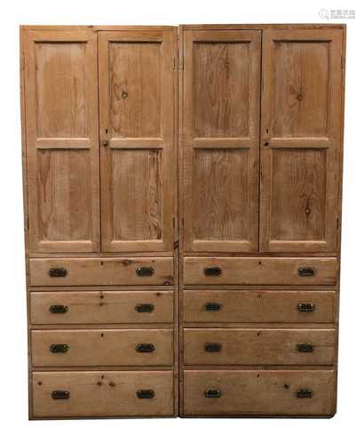 A pair of tall pale stripped pine hall cupboards