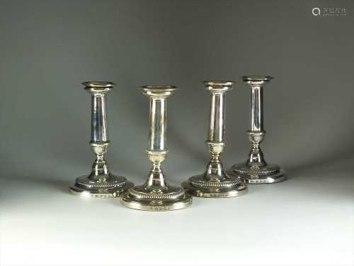 A set of four George III silver candlesticks