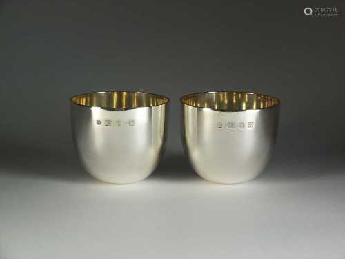 A pair of silver tumblers