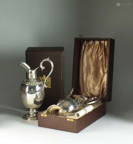 A pair of Garrards commemorative silver claret jugs