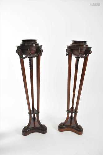 A pair of 19th century mahogany trefoil torcheres in the Adam style