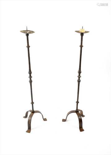 A tall pair of 18th century and later wrought iron floor-standing pricket stands,