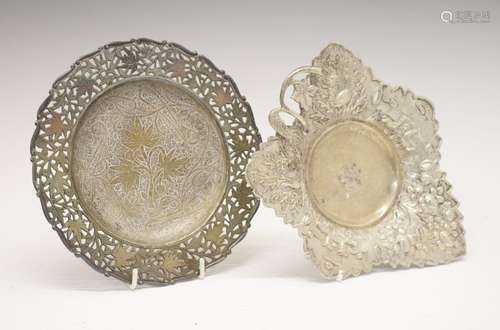 Middle Eastern white metal shaped dish with embossed naturalistic decoration and standing on three