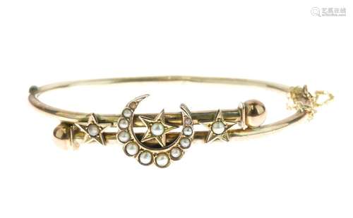 Edwardian seed pearl set hinged bangle, unmarked, with a crescent and stars frontispiece, internal