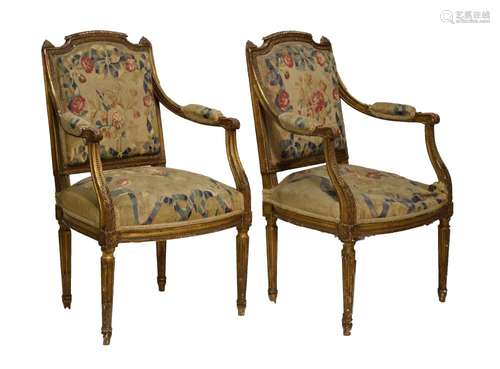 Pair of 19th Century Louis XVI- style giltwood fauteuils, each having a shaped arched padded back