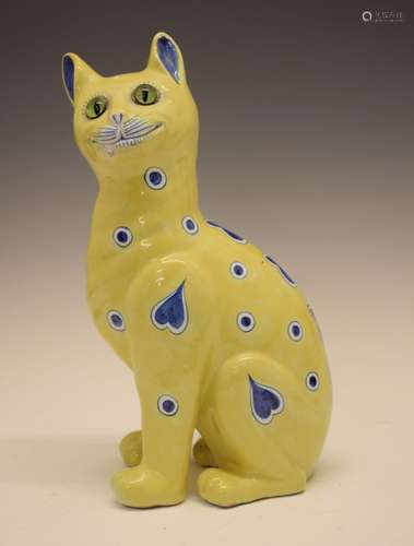 Continental faience model of a seated cat in the manner of Emile Gallé, having green glass eyes,