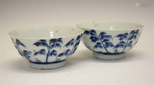 Pair of Chinese porcelain blue and white bowls, each decorated with tall trees in a landscape and