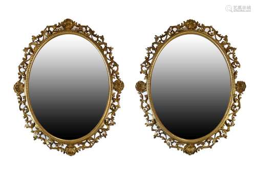 Pair of 19th Century giltwood and gesso oval wall mirrors, each having a plain plate with beaded