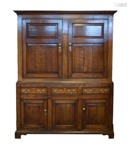 George III oak and mahogany press cupboard, the upper stage having a moulded cornice over a pair