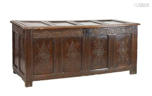 17th Century oak four-panel coffer, the hinged moulded cover over lunette-carved foliate frieze