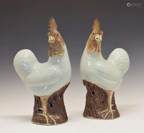 Pair of 20th Century Chinese porcelain figures of cockerels, each standing upon a tree stump base,