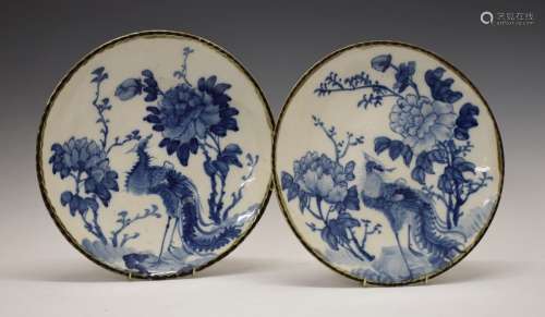 Pair of early 20th Century Oriental pottery plates, probably Japanese, each decorated in