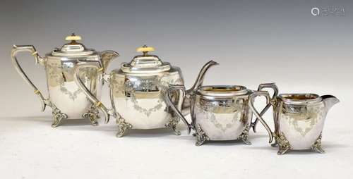 George V silver four piece tea set of rounded rectangular shape and having engraved floral