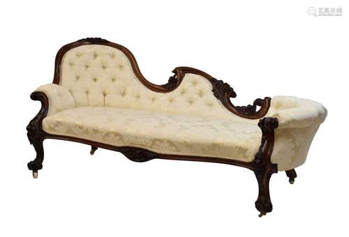 Victorian carved rosewood chaise longue, the deep-buttoned scooped back with cream foliate damask