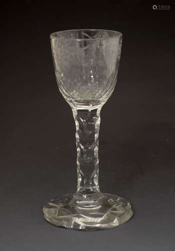 18th Century facet-cut cordial glass, the rounded funnel bowl engraved with flowers over facet-cut