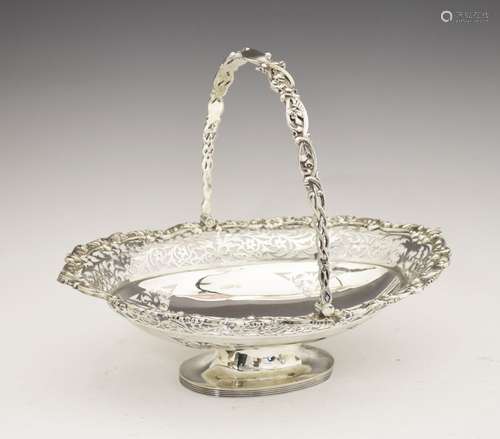 Edward VII silver oval cake basket, with pierced swing handle over wavy oval body having scroll-