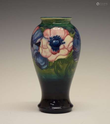 William Moorcroft 'Anemone' pattern pottery baluster vase, with tube-lined decoration on a ground