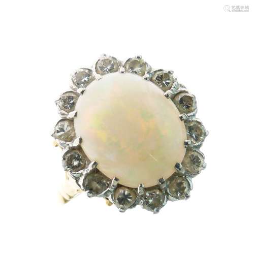 Opal and diamond cluster ring, unmarked, the oval cabochon measuring approximately 12.7mm x 10.4mm x