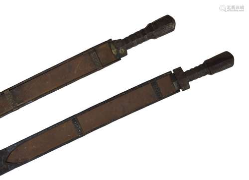 Two Bhutanese short swords 'BHA', grips of hardwood, wrapped with metal bands, flat single edged