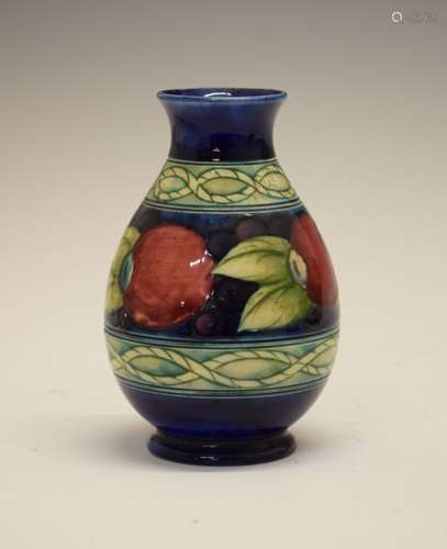 William Moorcroft baluster vase decorated with the banded Pomegranate pattern on a blue ground