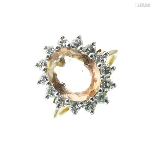 Topaz and diamond 18ct gold cluster ring, the oval cut stone measuring approximately 10mm x 7.9mm
