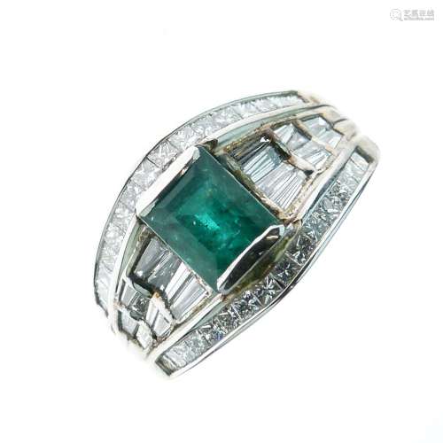Emerald and diamond dress ring, the white mount stamped '18k', the step cut stone between baguette