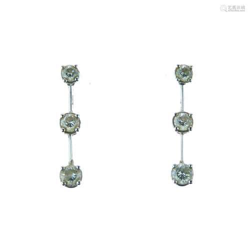 Pair of diamond drop earrings, in unmarked white metal, the graduated brilliant cuts totalling