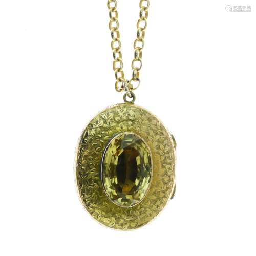 Late Victorian citrine set oval gold locket, unmarked, the leaf engraved locket 3.5cm x 2.8cm, on an